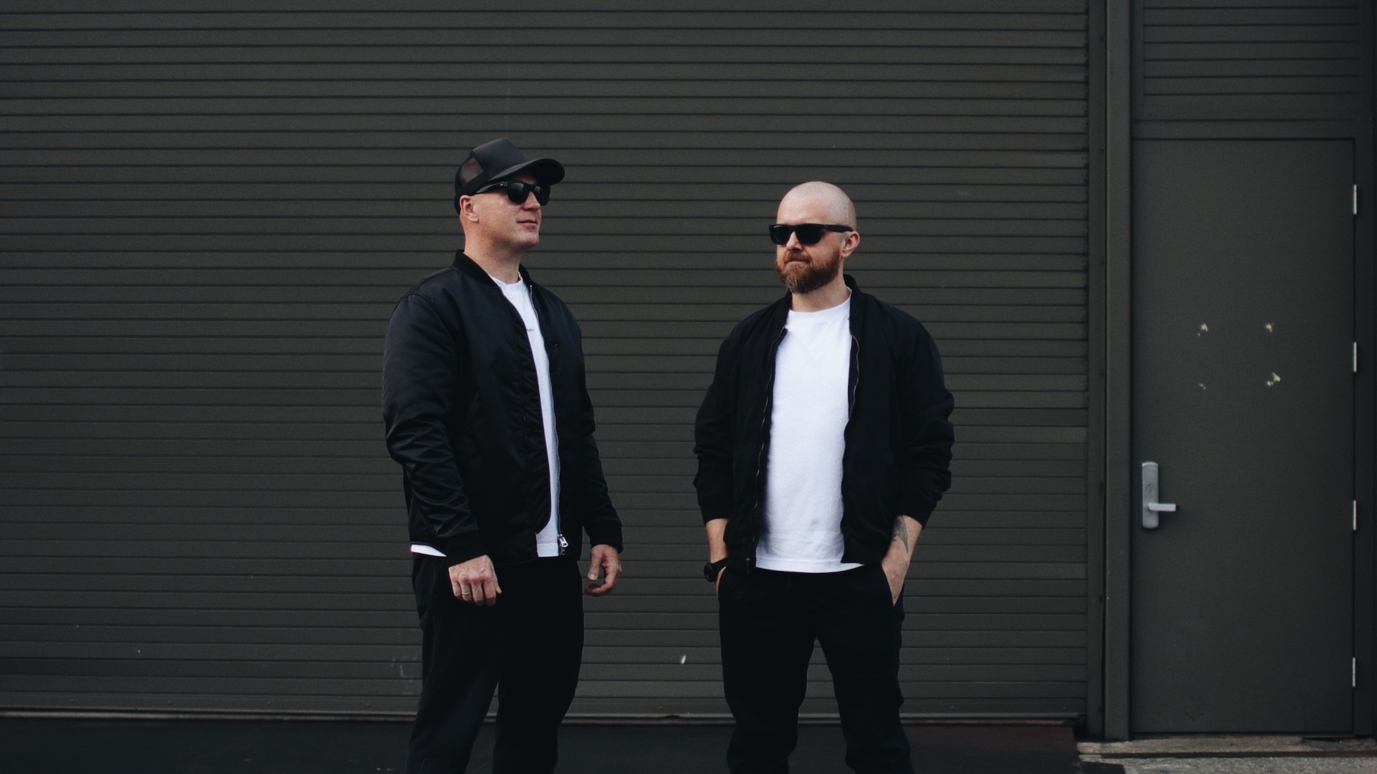 Mission Control founders Anton Zykin and Dima Tsozik together outside a dark garage door